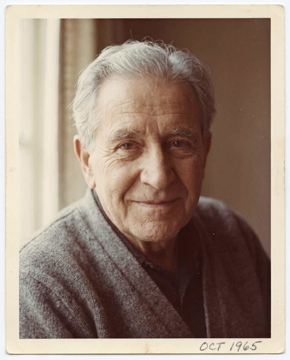 A vintage portrait of a silver-haired man, gently coming to life with natural color and motion